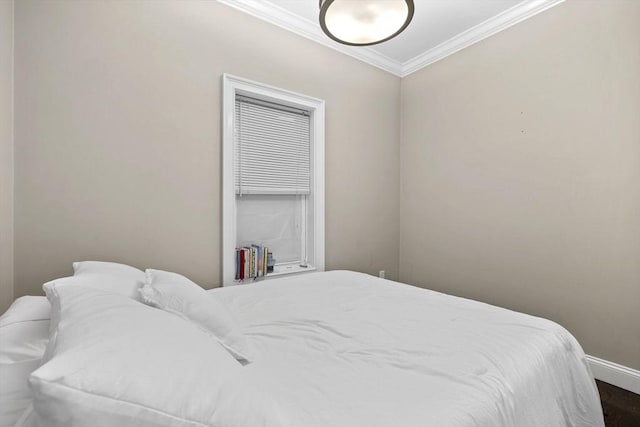 bedroom featuring ornamental molding and baseboards