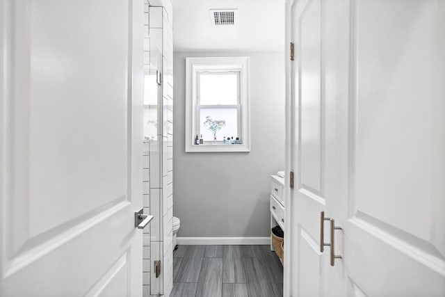 spacious closet featuring visible vents and dark wood finished floors