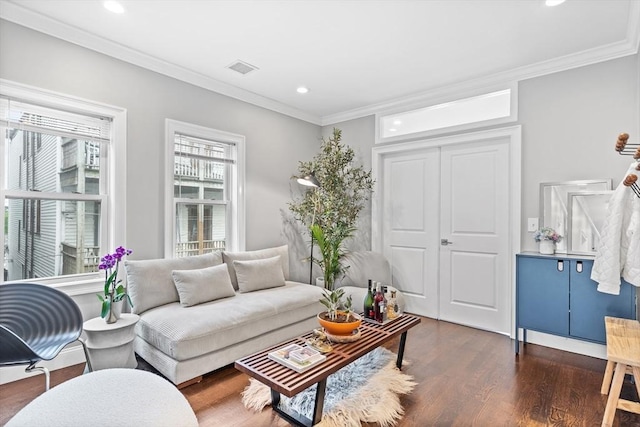 living area featuring crown molding, visible vents, recessed lighting, and wood finished floors