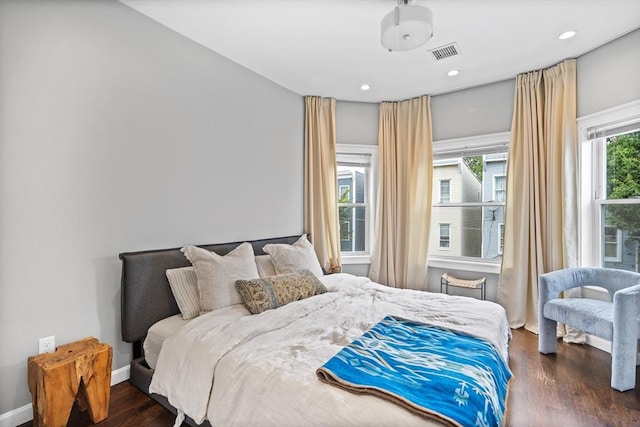 bedroom featuring visible vents, baseboards, dark wood-type flooring, and recessed lighting