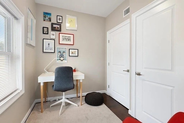 home office with a wealth of natural light, baseboards, and visible vents