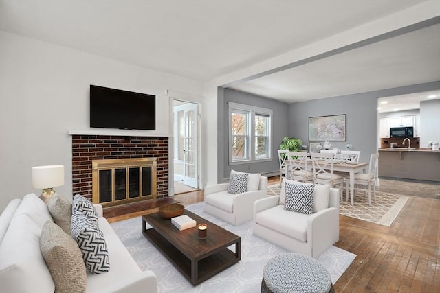 living area with wood-type flooring and a fireplace