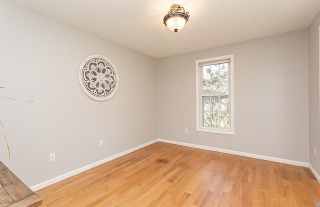 empty room featuring light wood-style flooring and baseboards