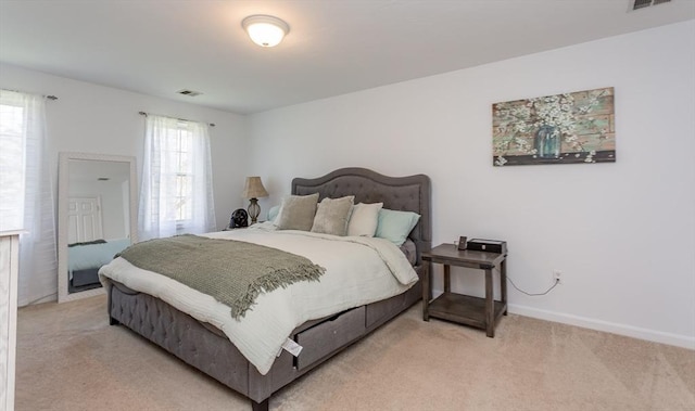 bedroom with light colored carpet, baseboards, and visible vents