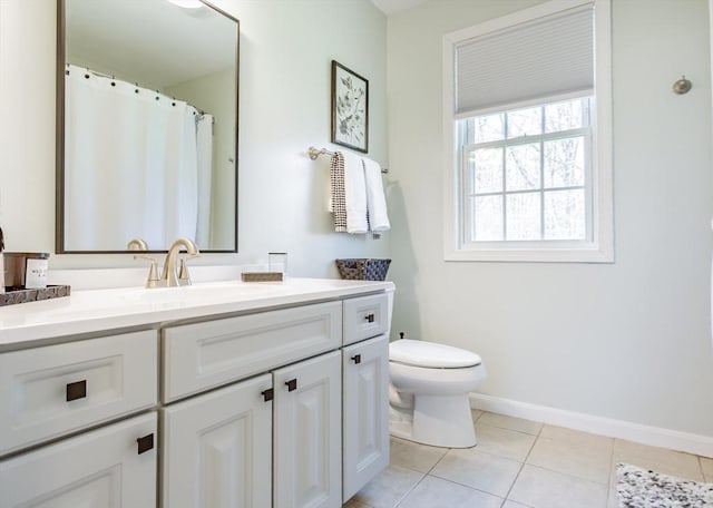 bathroom featuring baseboards, tile patterned floors, vanity, and toilet