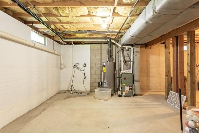 below grade area featuring water heater and heating unit