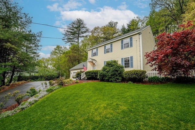 36 Westford Rd, Ayer, MA 01432 - colonial home with a front lawn, asphalt driveway, and a garage