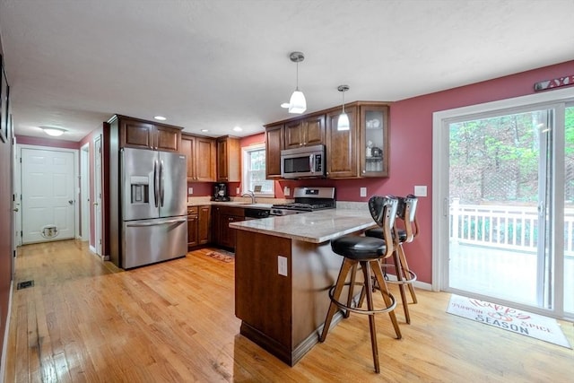 36 Westford Rd, Ayer, MA 01432 - kitchen with appliances with stainless steel finishes, a peninsula, light wood-style floors, a sink, and recessed lighting