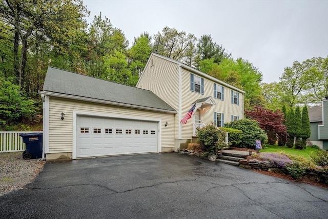 36 Westford Rd, Ayer, MA 01432 - view of front of property with driveway, a garage, and view of scattered trees