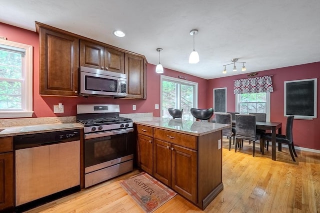 36 Westford Rd, Ayer, MA 01432 - kitchen featuring appliances with stainless steel finishes, a peninsula, light wood finished floors, decorative light fixtures, and recessed lighting