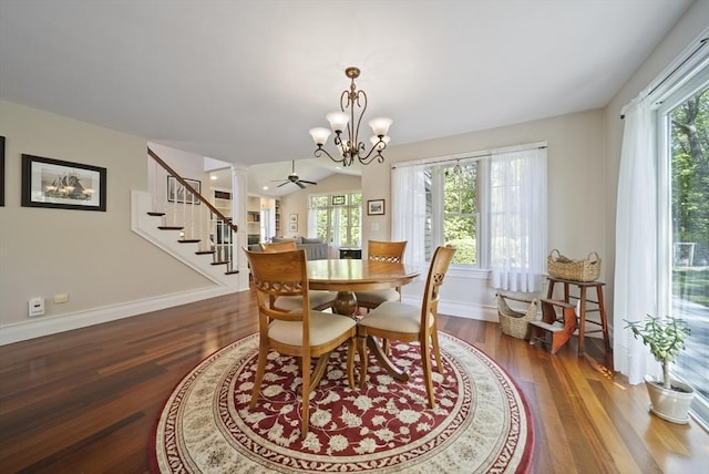 dining room with plenty of natural light, wood finished floors, stairway, and a chandelier