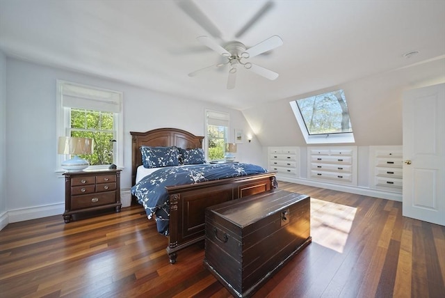 bedroom with multiple windows, dark wood-style flooring, a skylight, and ceiling fan