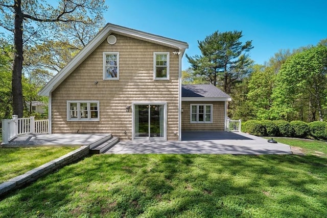 rear view of property with a patio area and a yard