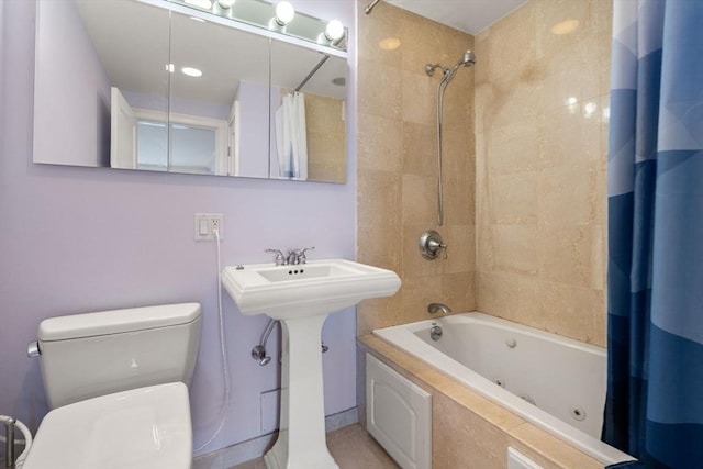 full bath featuring toilet and a combined bath / shower with jetted tub