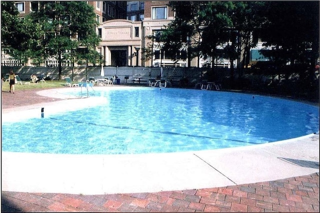 community pool featuring a patio and fence