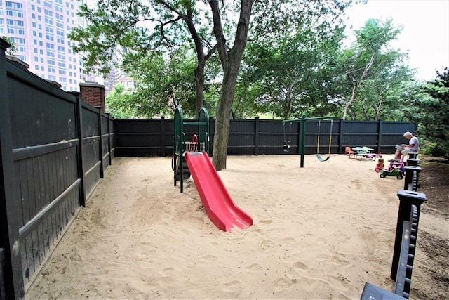 communal playground featuring fence