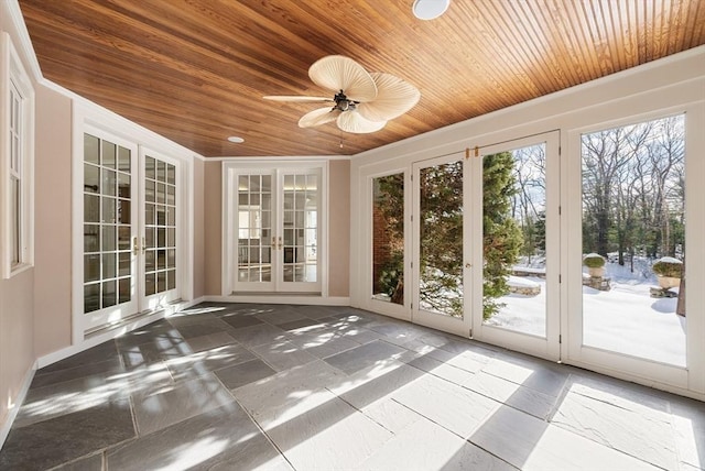 unfurnished sunroom featuring ceiling fan, french doors, and wood ceiling