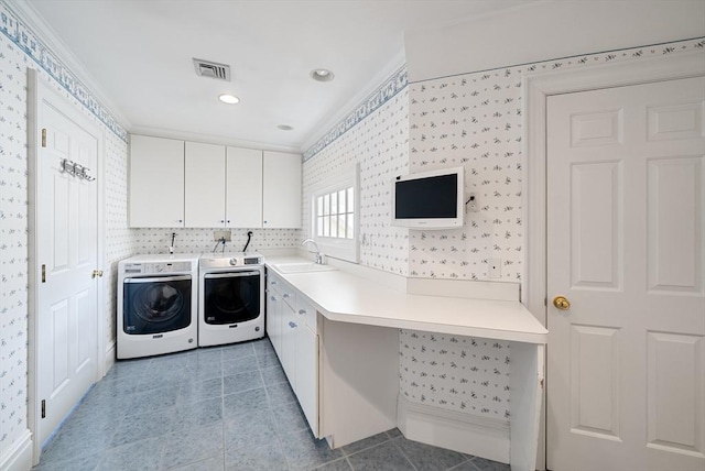 clothes washing area featuring light tile patterned floors, a sink, visible vents, cabinet space, and washing machine and clothes dryer