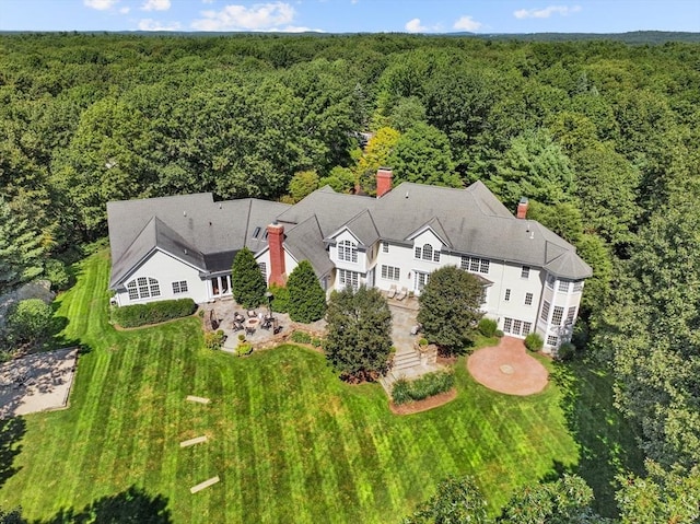 drone / aerial view with a wooded view