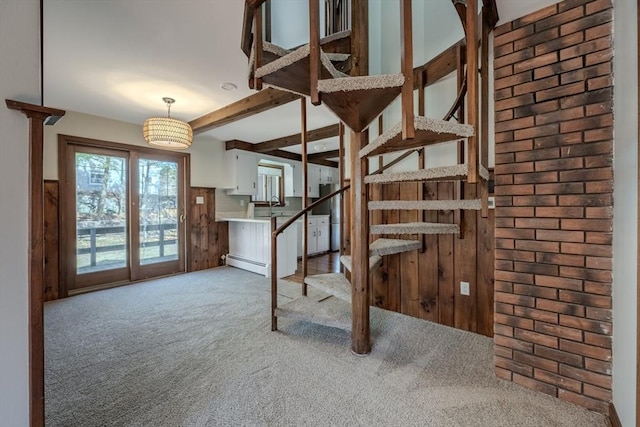 stairs with beam ceiling, carpet, and a baseboard radiator