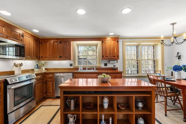 kitchen with an inviting chandelier, open shelves, recessed lighting, a sink, and stainless steel appliances