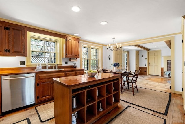 kitchen with a wealth of natural light, dishwasher, a notable chandelier, and wooden counters