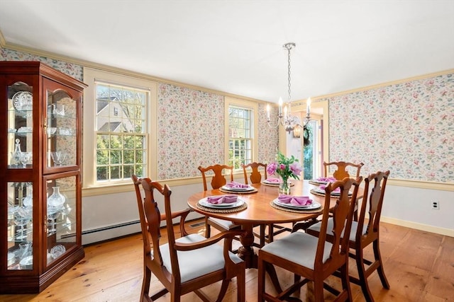 dining room with crown molding, baseboards, wallpapered walls, light wood finished floors, and a notable chandelier