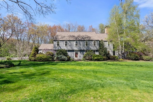 colonial house with a front lawn and a chimney