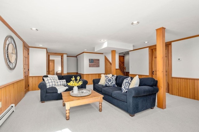 carpeted living area featuring wood walls, stairway, a wainscoted wall, a baseboard radiator, and recessed lighting