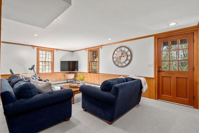 carpeted living area with recessed lighting, ornamental molding, a wainscoted wall, and wooden walls