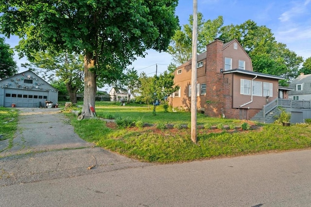 295 Rock Island Rd, Quincy, MA 02169 - view of side of home featuring a garage, an outdoor structure, and a chimney
