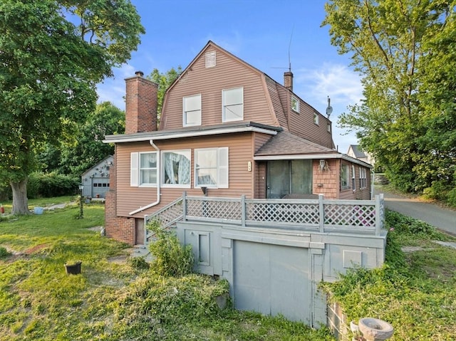 295 Rock Island Rd, Quincy, MA 02169 - view of front of house featuring a chimney, a gambrel roof, stairway, and roof with shingles