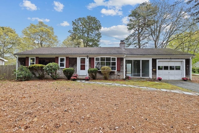 single story home featuring a garage, a chimney, fence, asphalt driveway, and a shingled roof