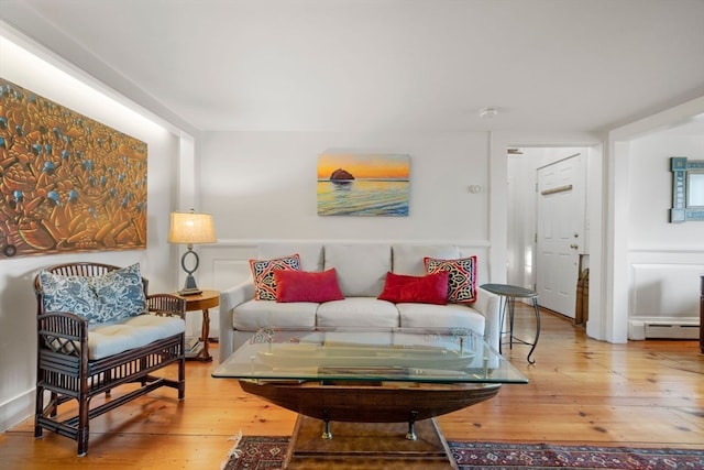 living room with hardwood / wood-style flooring and a baseboard radiator