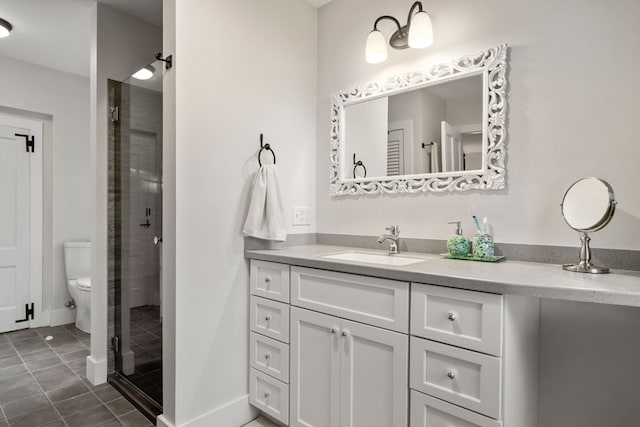 bathroom with vanity, tile patterned flooring, toilet, and an enclosed shower