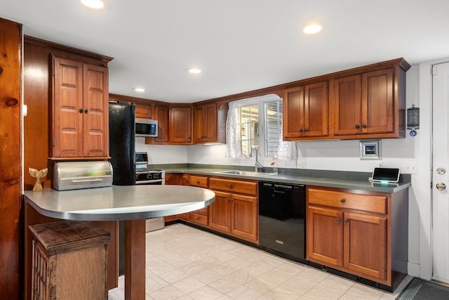 kitchen with appliances with stainless steel finishes, a breakfast bar, and sink