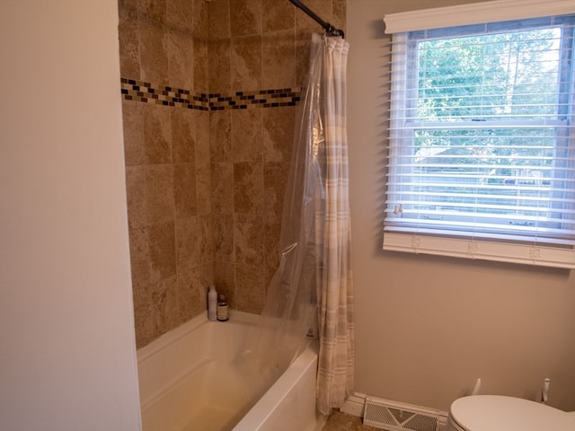 bathroom featuring toilet and shower / bath combo