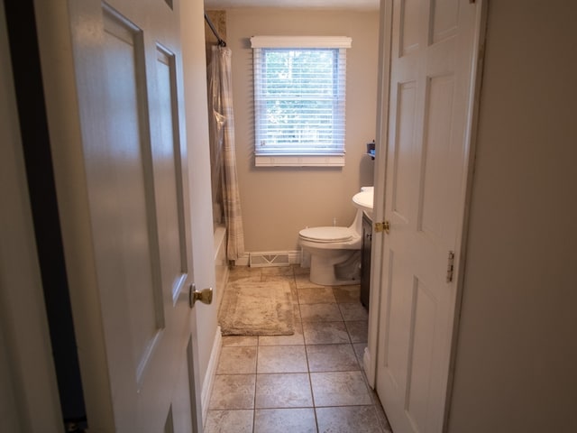 full bathroom with vanity, toilet, tile patterned floors, and shower / bath combo with shower curtain