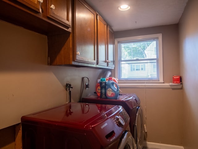 washroom featuring independent washer and dryer and cabinets