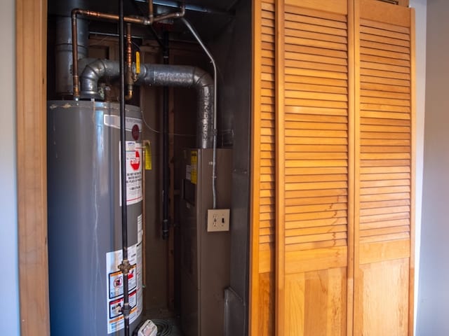 utility room with water heater