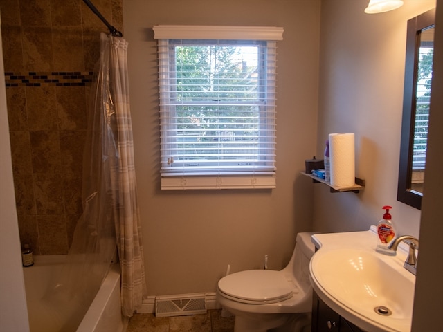 full bathroom with toilet, a healthy amount of sunlight, vanity, and shower / bath combination with curtain