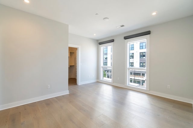 spare room with hardwood / wood-style flooring