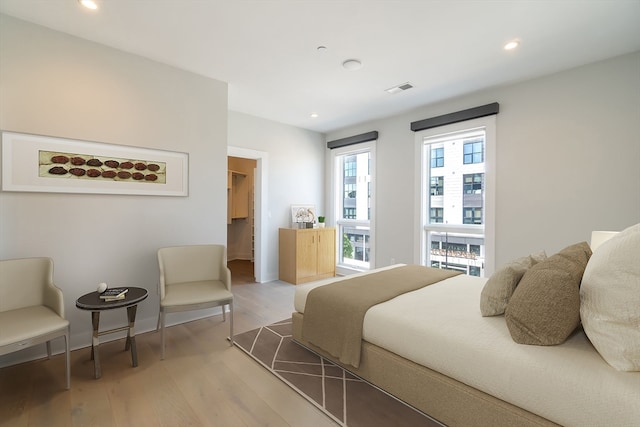 bedroom featuring a spacious closet and light wood-type flooring