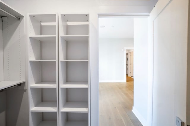 spacious closet with light hardwood / wood-style floors