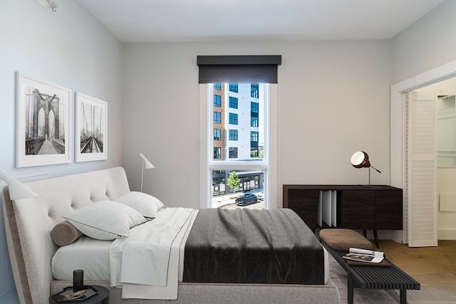 bedroom with hardwood / wood-style flooring