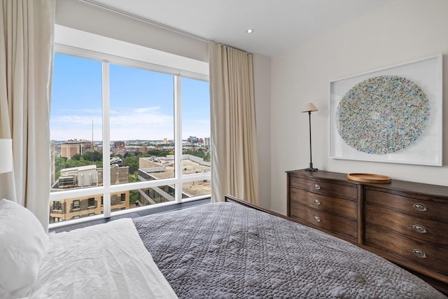 bedroom featuring multiple windows and floor to ceiling windows