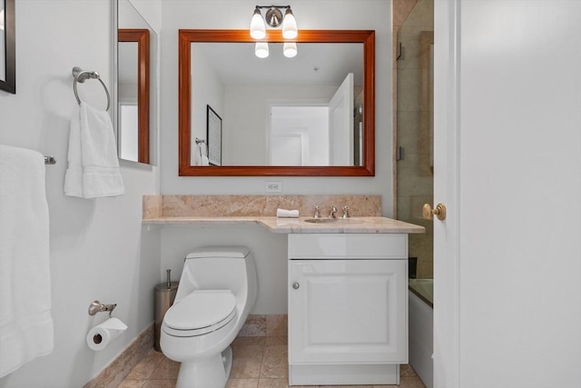 full bathroom with tile patterned flooring, vanity, bath / shower combo with glass door, and toilet