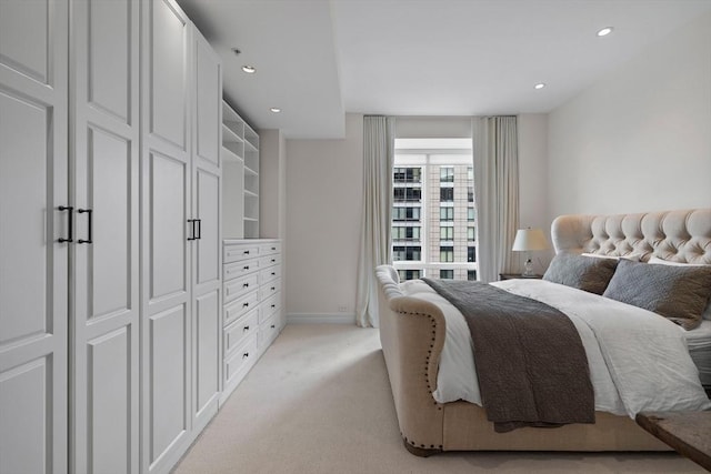 bedroom with light colored carpet and a closet