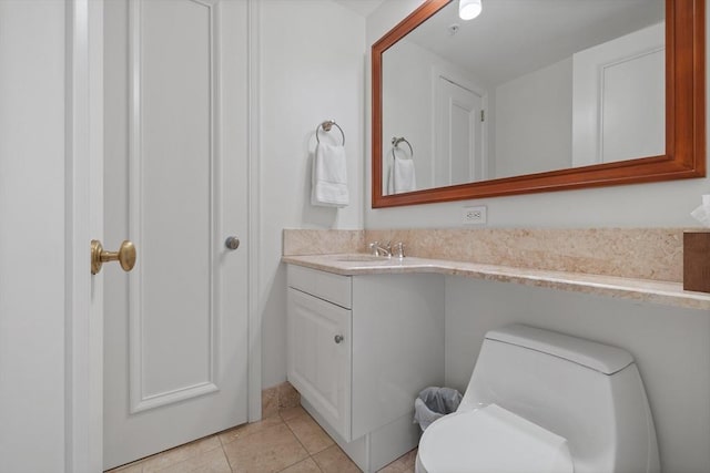 bathroom featuring tile patterned flooring, vanity, and toilet