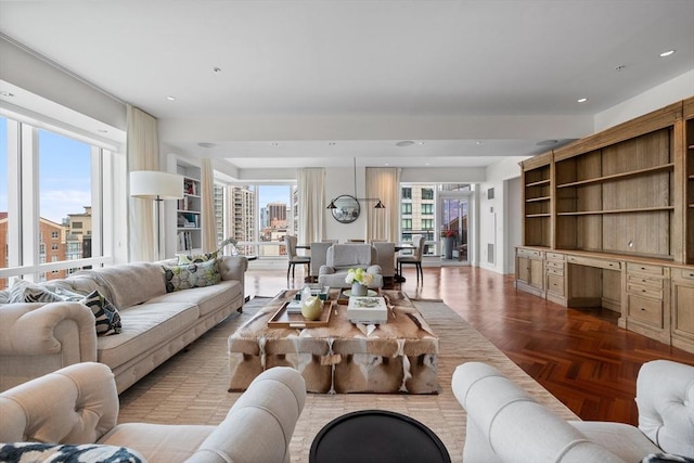 living room with built in desk and light parquet flooring